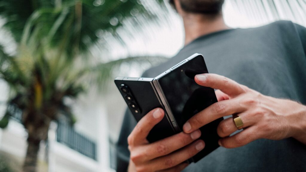 Mann hält ein Smartphone in beiden Händen